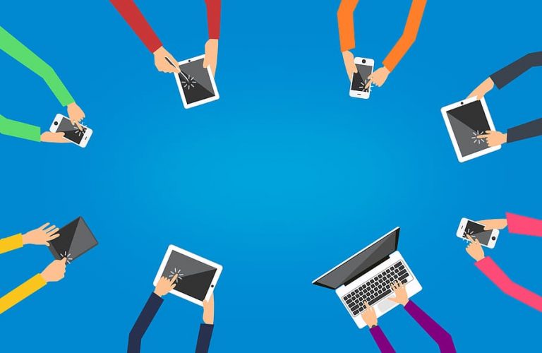 Colorful illustrated arms holding smartphones and tablets arranged in a circle on a vibrant blue background, conveying global connectivity and collaboration